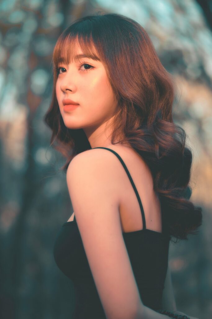 A beautiful portrait of an Asian woman outdoors with elegant style and natural lighting.